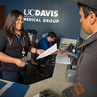 "woman handing a form to a client"