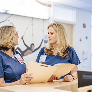 "two uc davis RNs talking with one another"