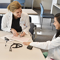 "female doctor talking to a colleague"