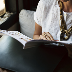 "woman reading through a booklet"