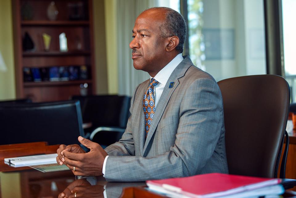 Chancellor May sitting at desk. 