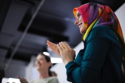 image of a woman clapping and smiling