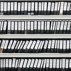 "shelf of ring binders"