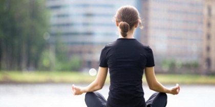 back of a woman meditating