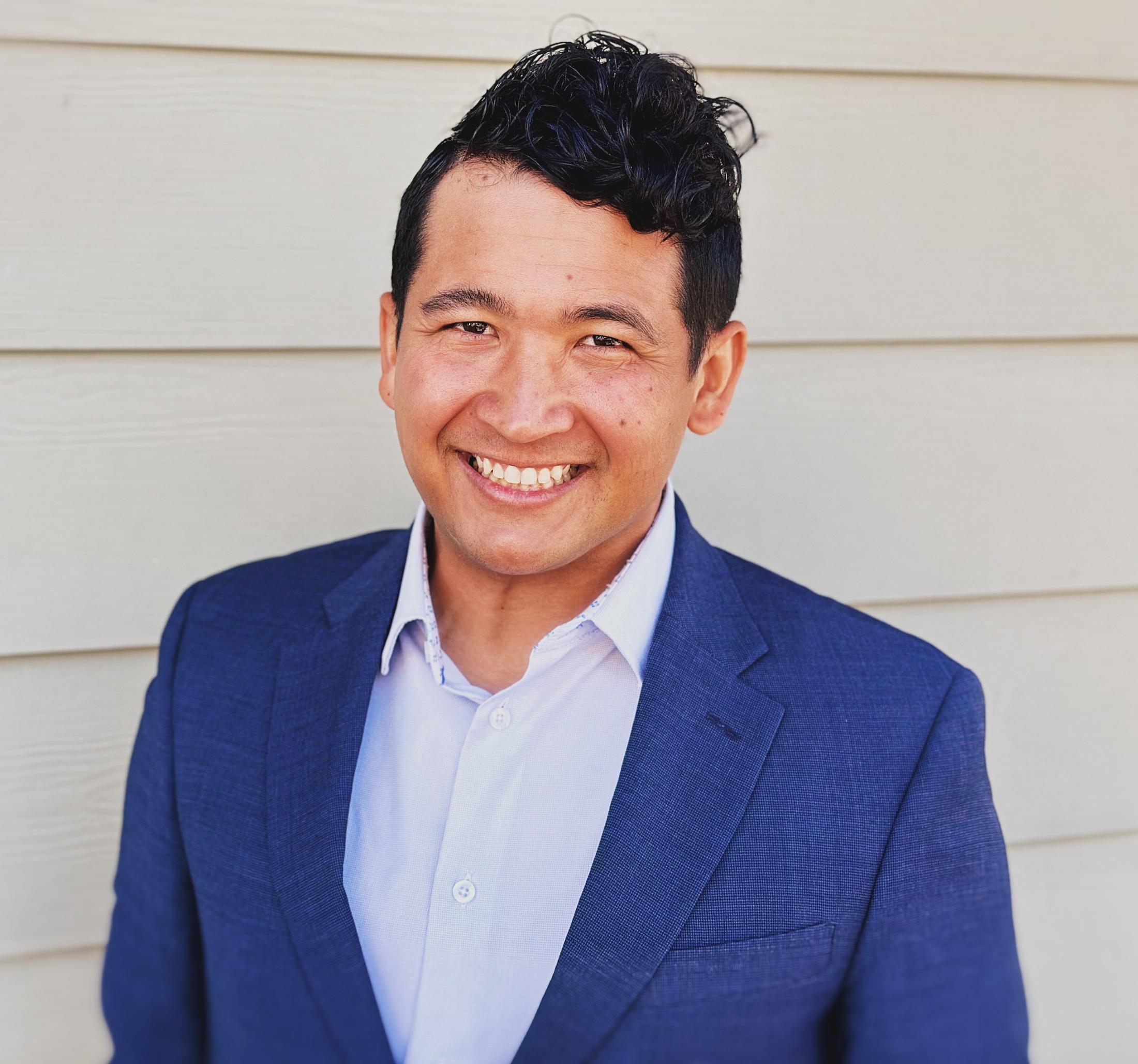 man in blue suit smiling