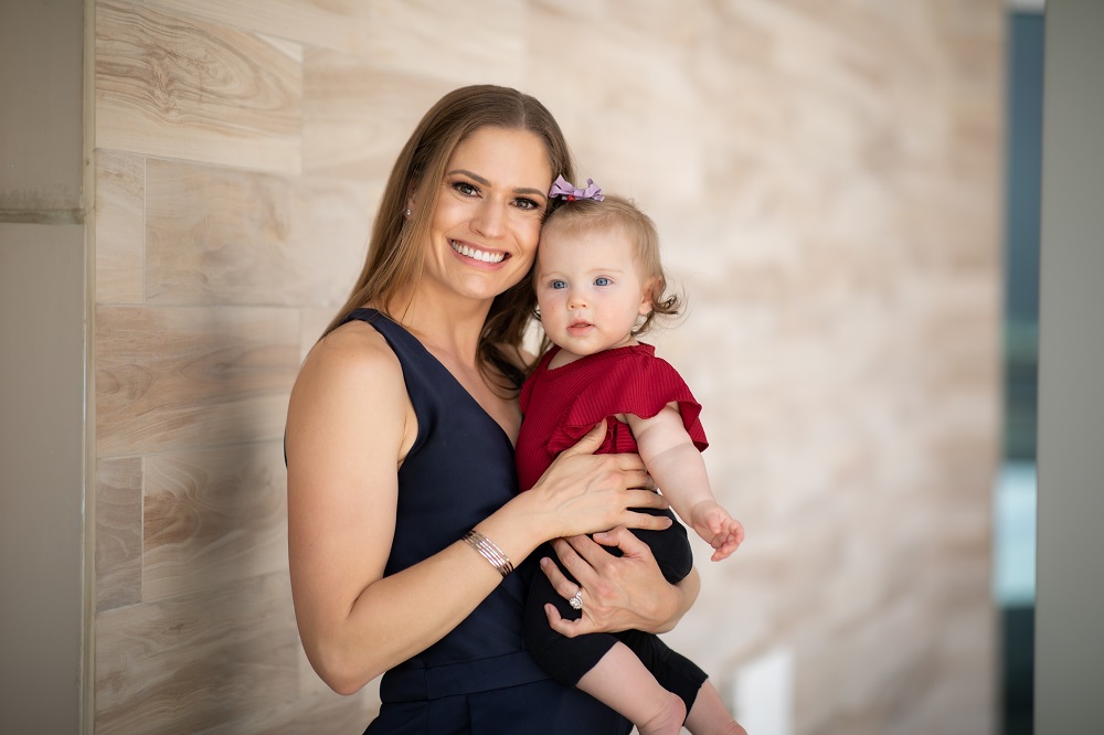 Employee Erin and baby smiling at camera
