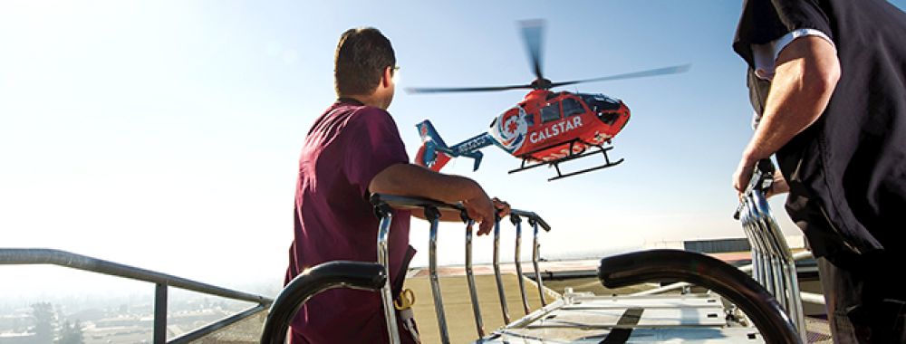 two doctors waiting on a medical helicopter to land