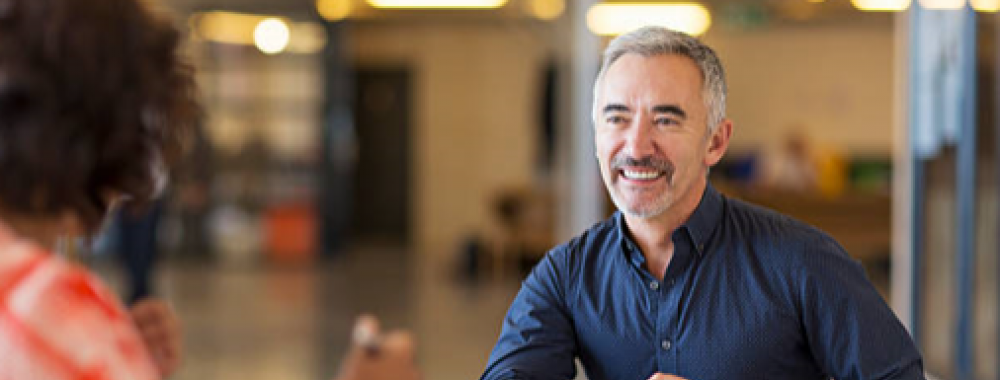 smiling man having an interview with a woman