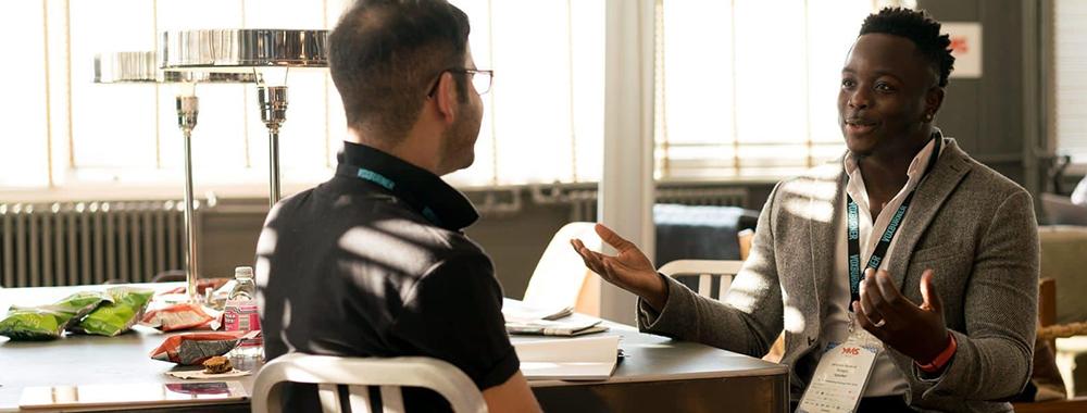 two men at a table having a conversation