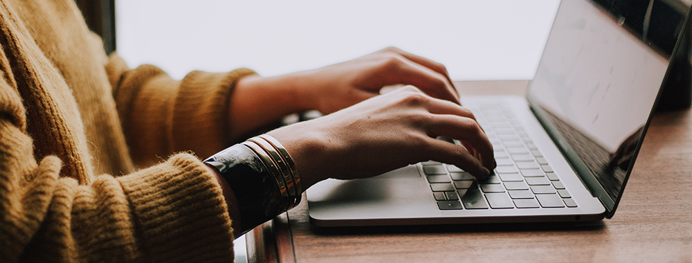 Person typing on a laptop.