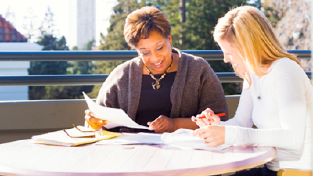 older woman listening while a younger woman speaks