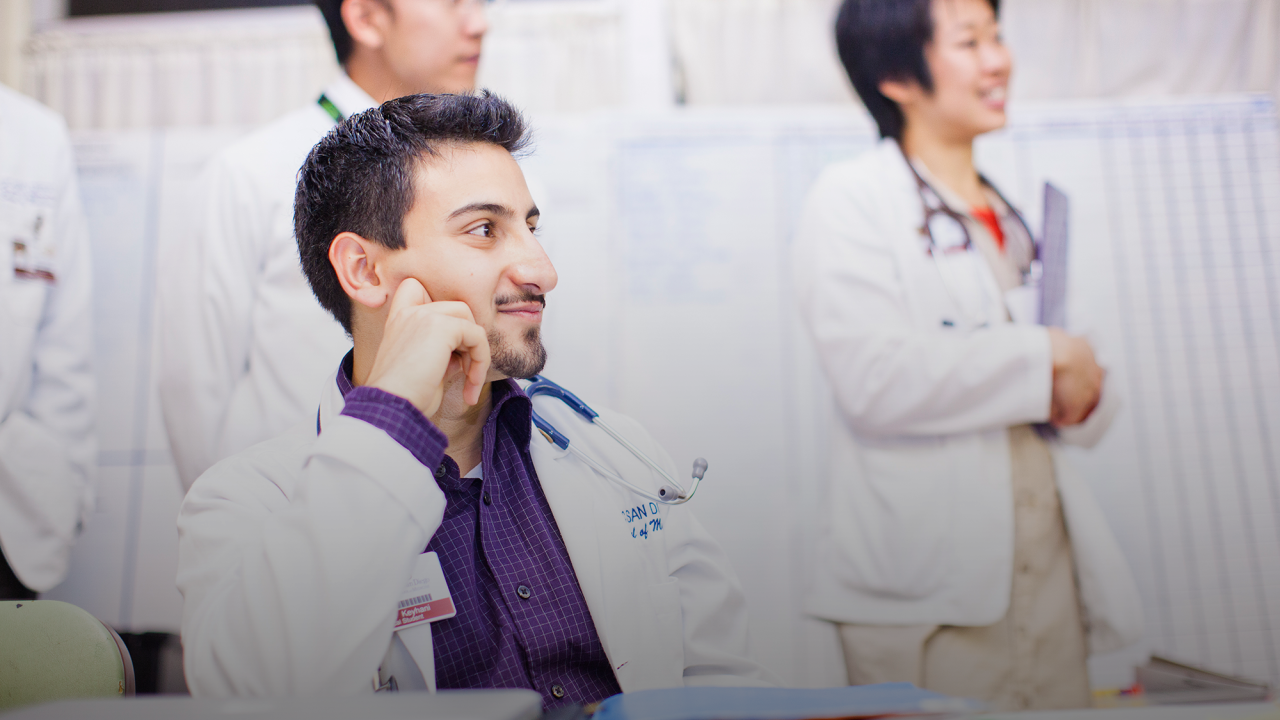 three doctors listening to a presentation