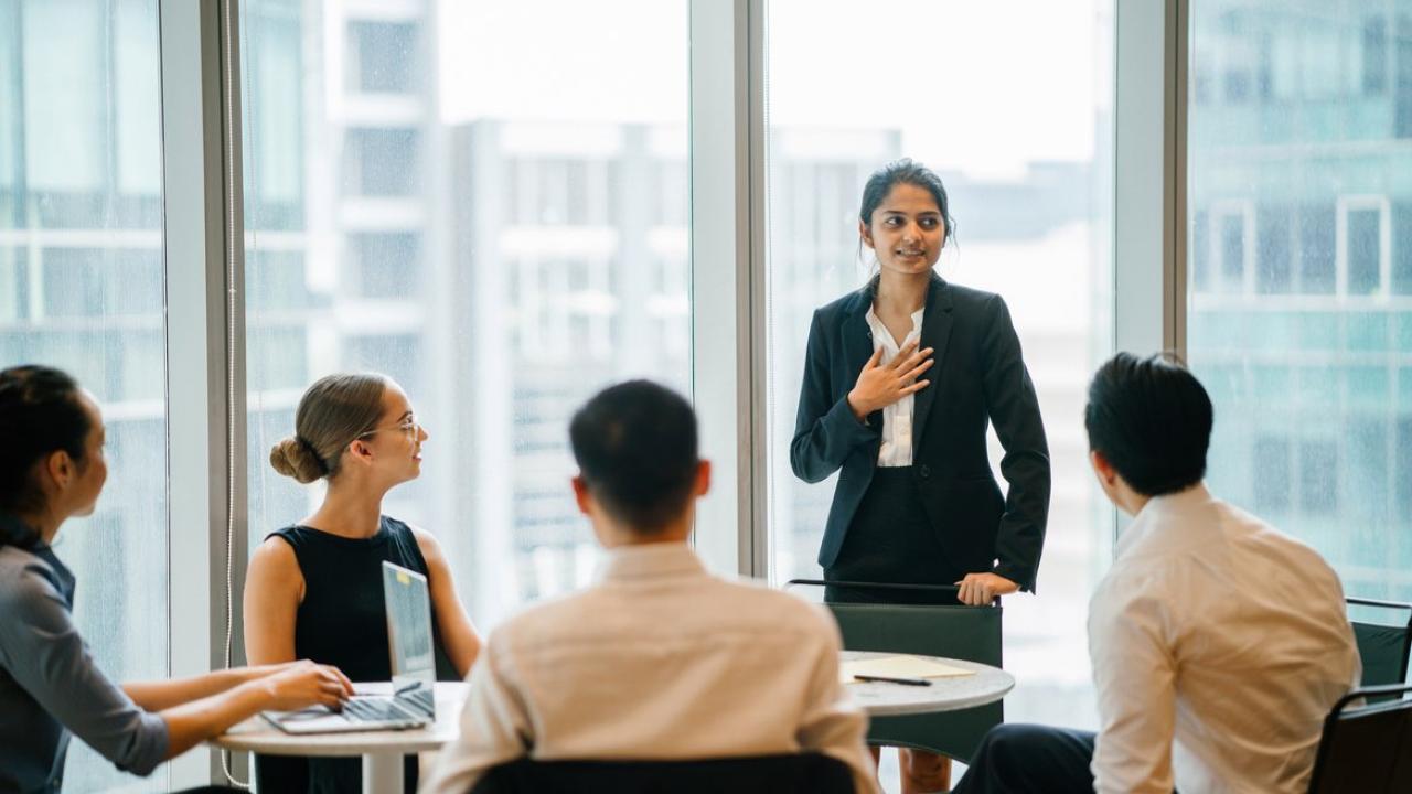 Woman sharing at business meeting. 