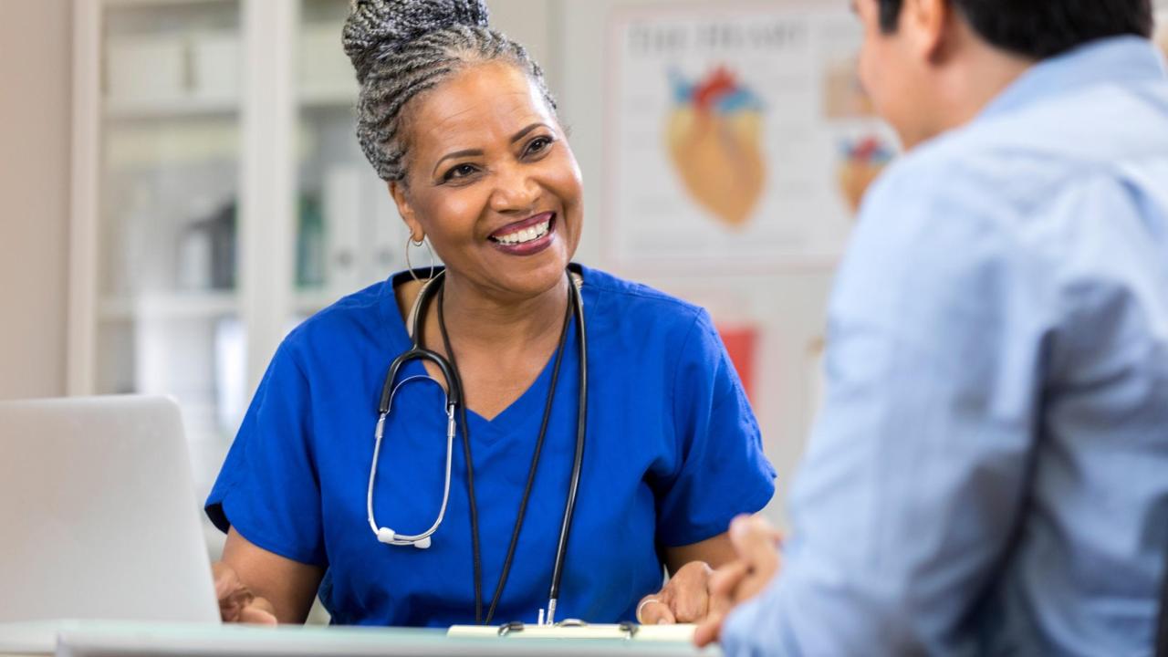 nurse talking with patient smiling