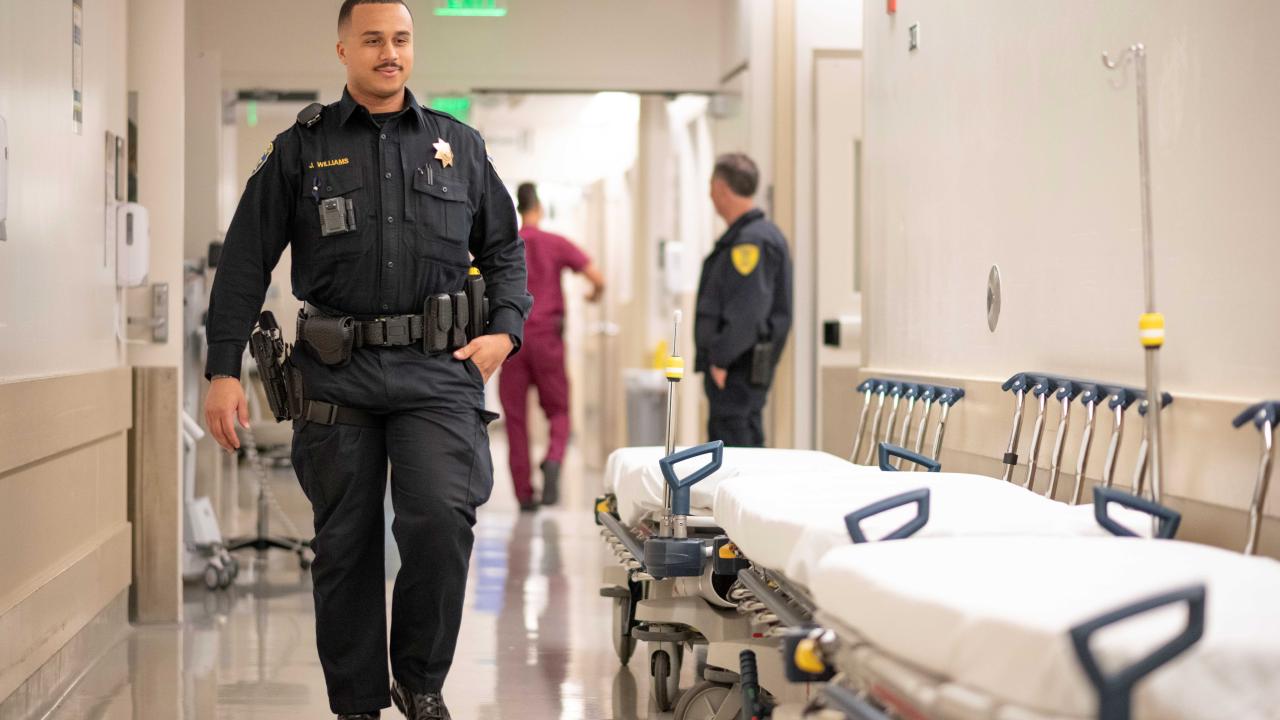 Police officer walking down the hospital hallway.  