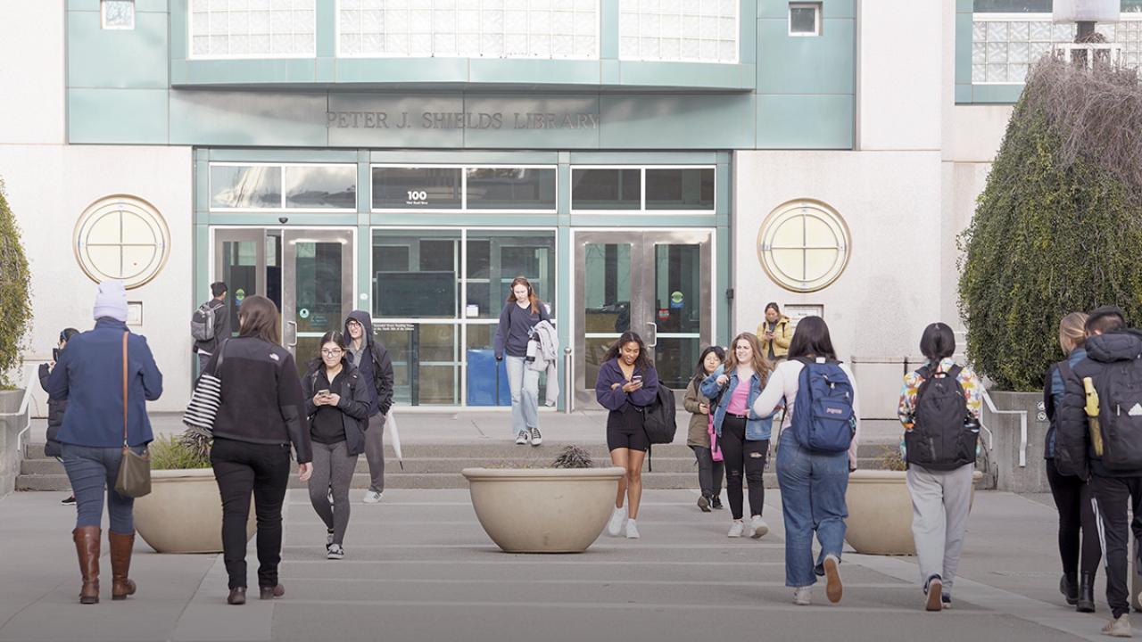People walking in front of building.