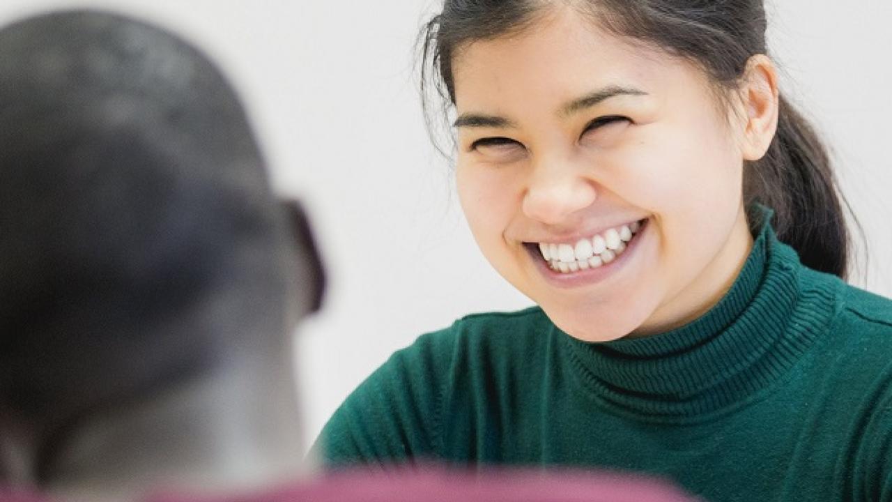 new employee smiling at another.