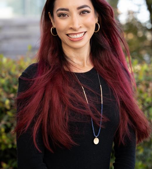 Monica wearing black top, trees in the background