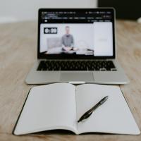 Photo of a laptop computer and a notebook.