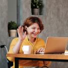 Woman in a wheelchair with a laptop on a video call 