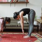 woman and her daughter stretching together