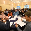 Group of people meeting around a table at conference.