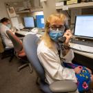 Doctor talking on phone in front of computer