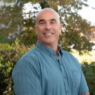 Glenn wearing blue shirt, trees in background