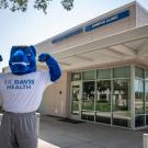 Gunrock flexing standing in front of UC Davis Health Davis Clinic