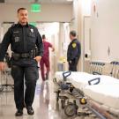 Police officer walking down the hospital hallway.  