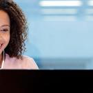 Woman smiling at laptop 