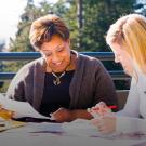 Photo of two people reviewing documents together.