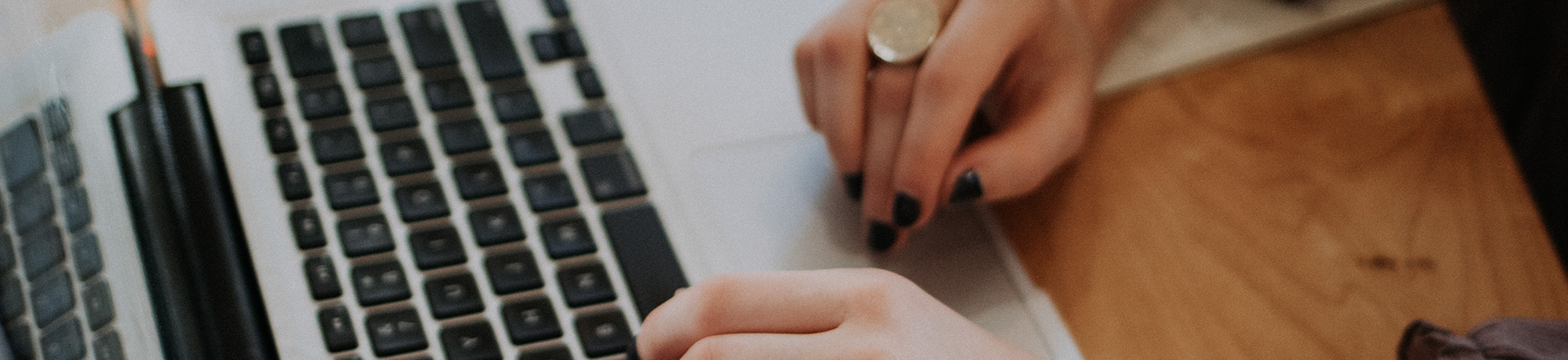 woman's hands using a laptop