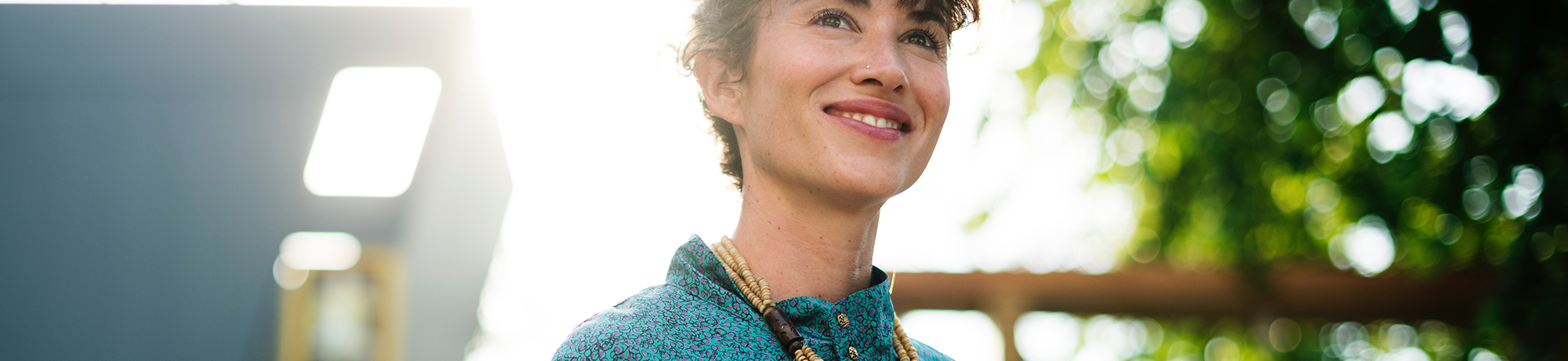 woman looking upwards while smiling