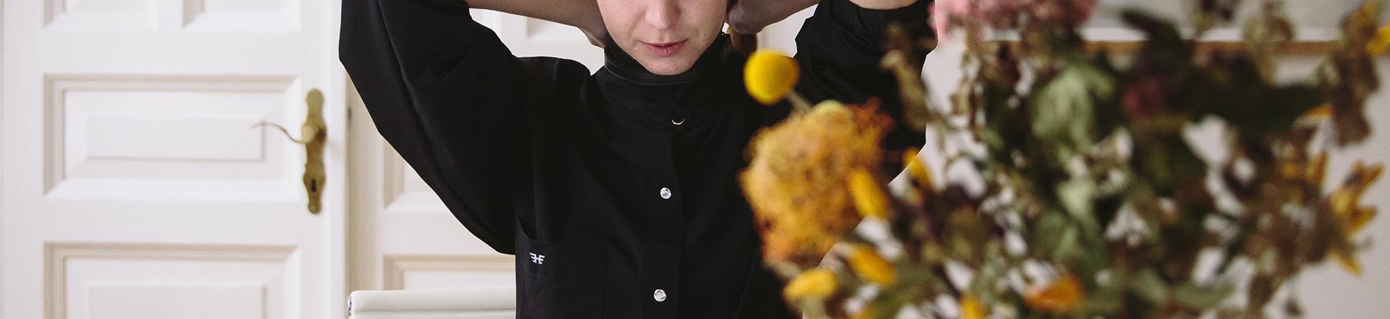 woman working at a kitchen table on laptop