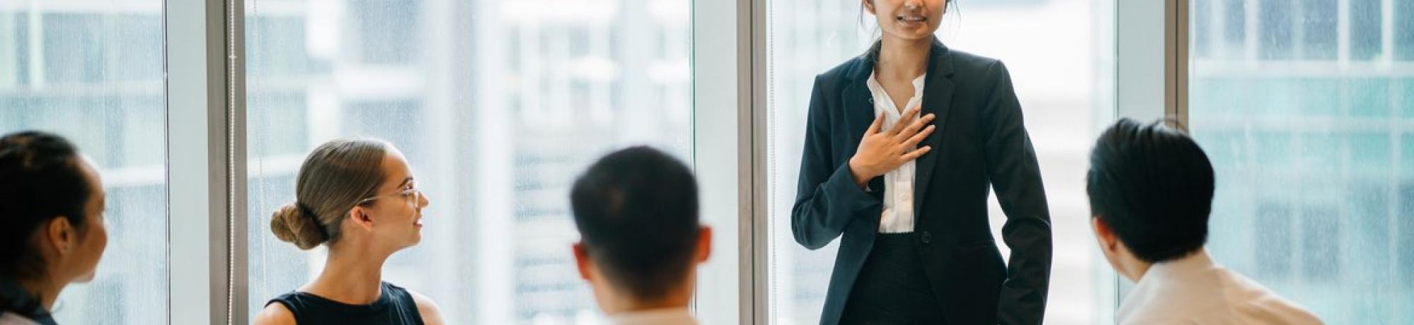 Woman sharing at business meeting. 