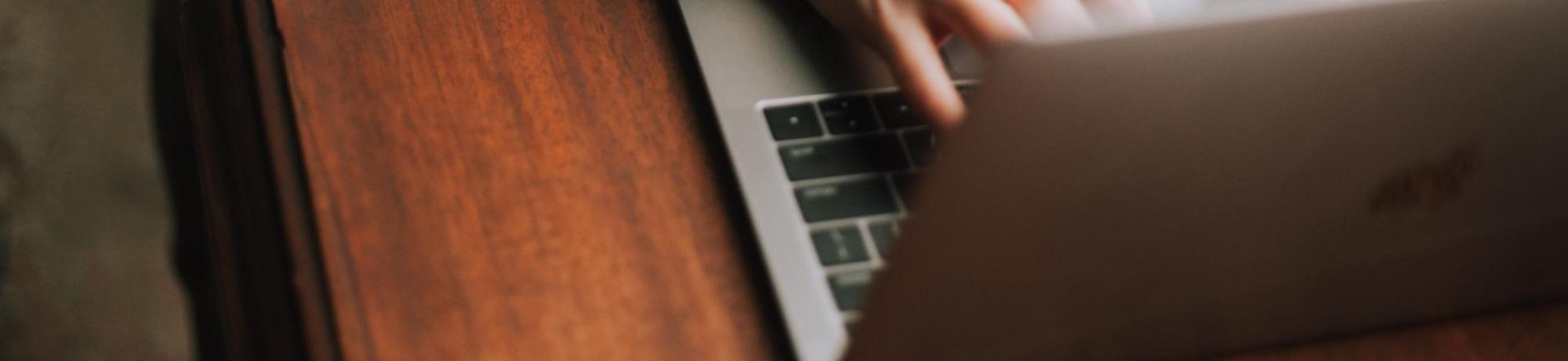 Person typing on a laptop computer.